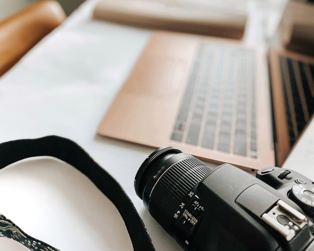 Laptop, camera, desk — Buying a 2nd Hand Car? Here's How to Get the Best Deal at an Affordable Price