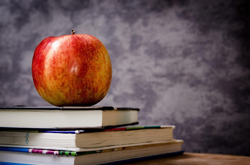 Apple, books, still life — Economics Tuition Singapore Offers Cost-Effective Learning Without Compromise