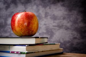 Apple, books, still life — Economics Tuition Singapore Offers Cost-Effective Learning Without Compromise